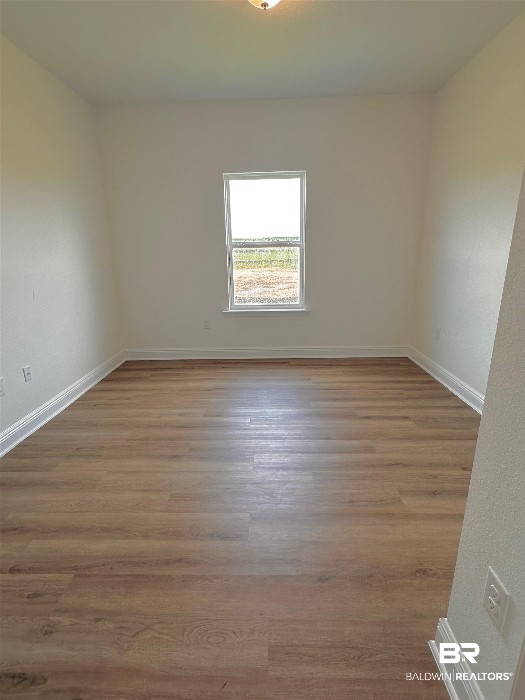 12946 Grand Rpds Road Fairhope, AL 36532 - Photo 7 of 19 Unfurnished room featuring hardwood / wood-style flooring