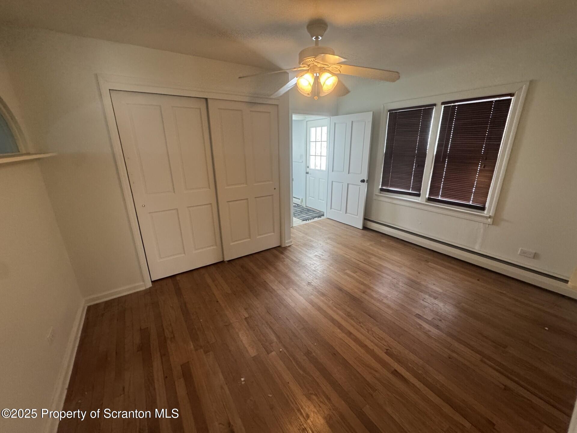 910 Bernard Avenue Clarks Summit, PA 18411 - Photo 11 of 17 an empty room with wooden floor and window