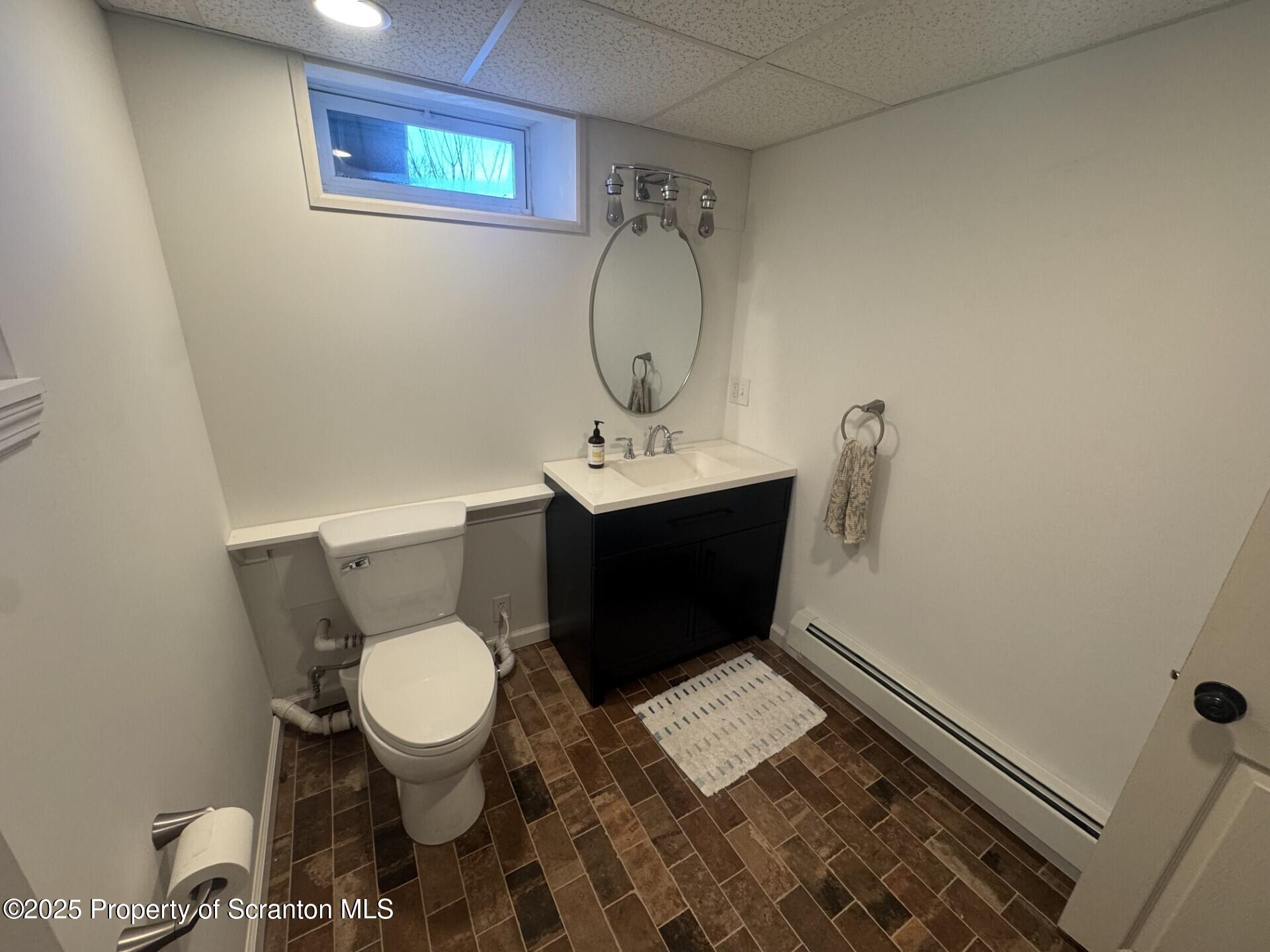 910 Bernard Avenue Clarks Summit, PA 18411 - Photo 14 of 17 a bathroom with a toilet mirror and vanity