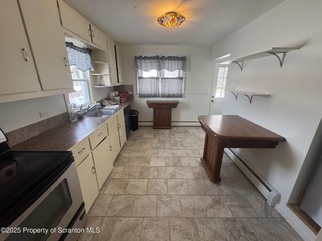 a kitchen with a sink cabinets and window
