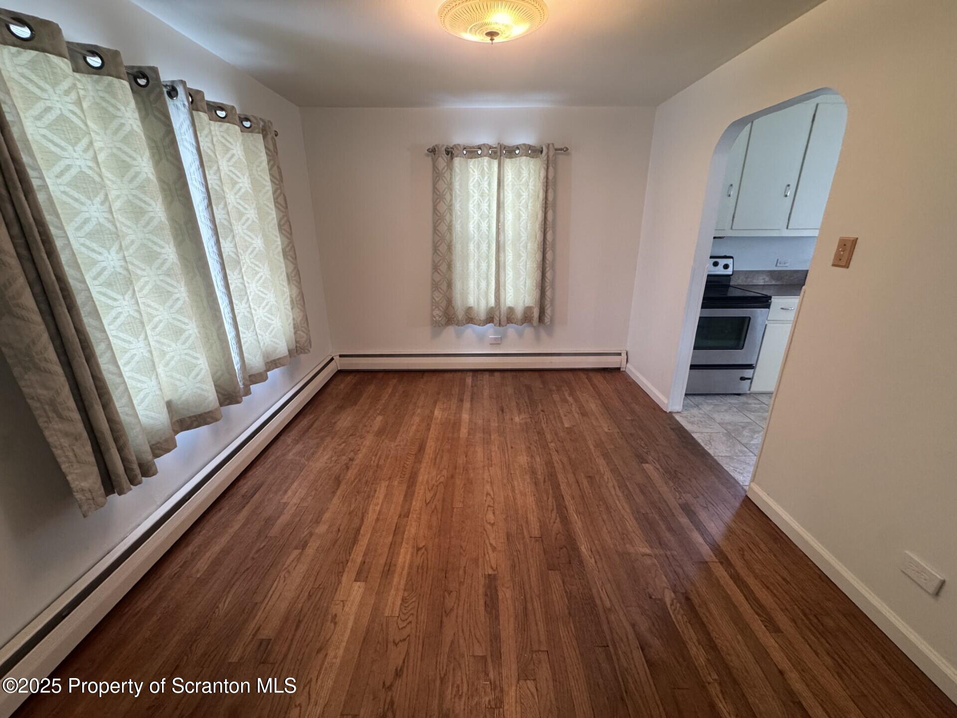910 Bernard Avenue Clarks Summit, PA 18411 - Photo 6 of 17 wooden floor in an empty room with a window