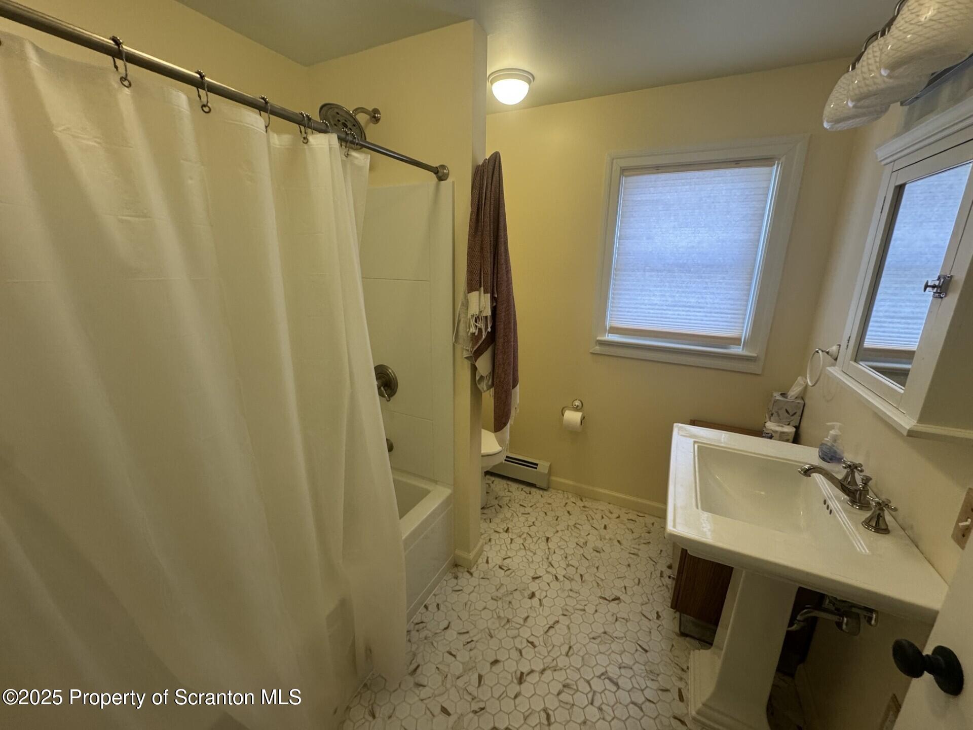 910 Bernard Avenue Clarks Summit, PA 18411 - Photo 7 of 17 a bathroom with a sink a mirror and a shower