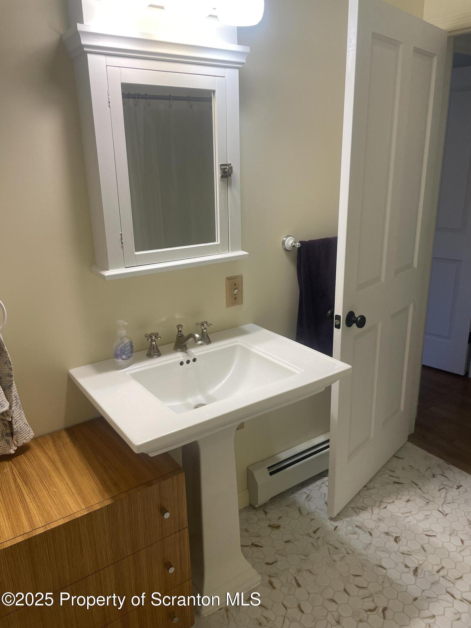 910 Bernard Avenue Clarks Summit, PA 18411 - Photo 8 of 17 a bathroom with a sink a toilet and mirror