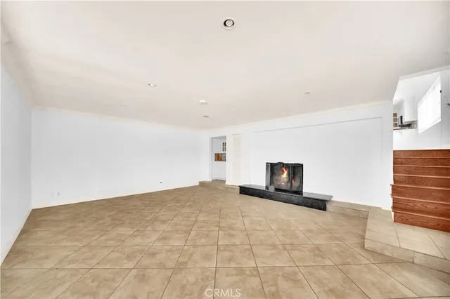 a view of a livingroom with an empty space and a fireplace