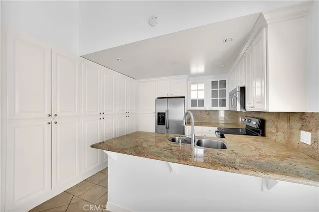 a view of kitchen with refrigerator sink and stove