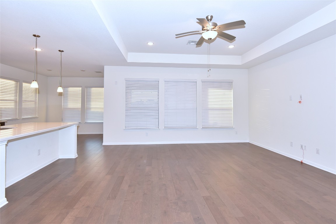5008 Risana Bend Round Rock, TX 78665 - Photo 6 of 21 wooden floor in an empty room with a kitchen