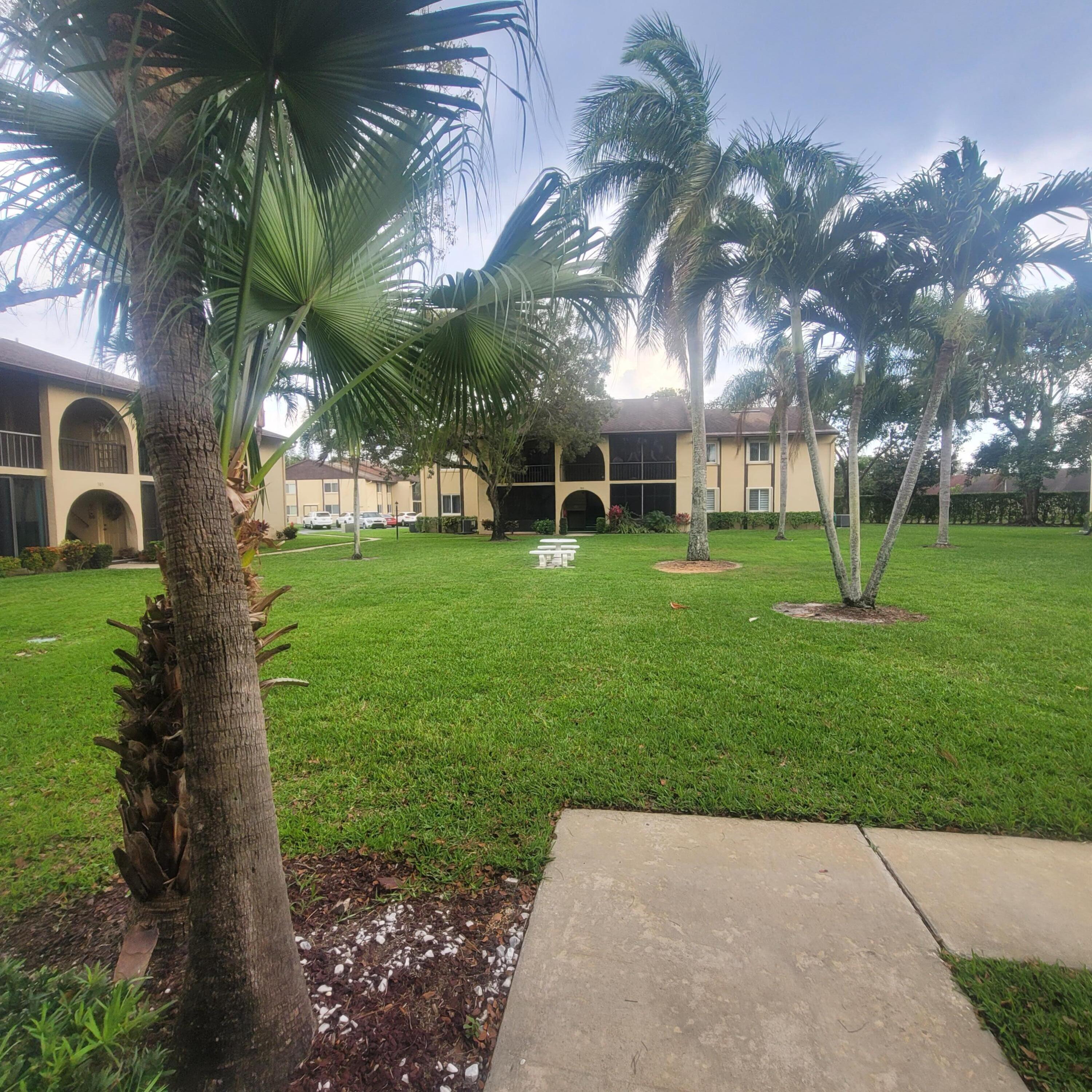 301 Pine Ridge Circle, Unit B1 Greenacres, FL 33463 - Photo 1 of 13 a view of a house with a yard