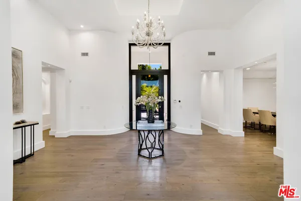 a view of an entryway with wooden floor