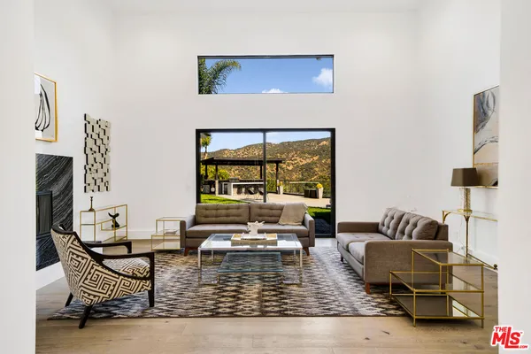 a living room with furniture or couch and a large window