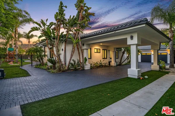 a front view of house with yard and outdoor seating