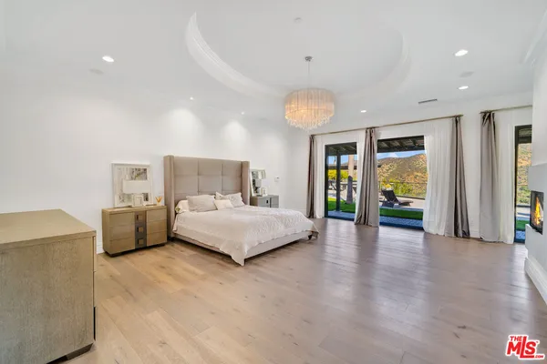 a spacious bedroom with a bed and a large window