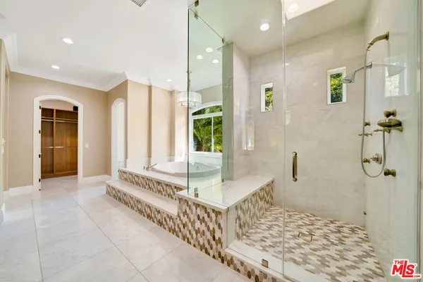 a bathroom with a tub shower and window