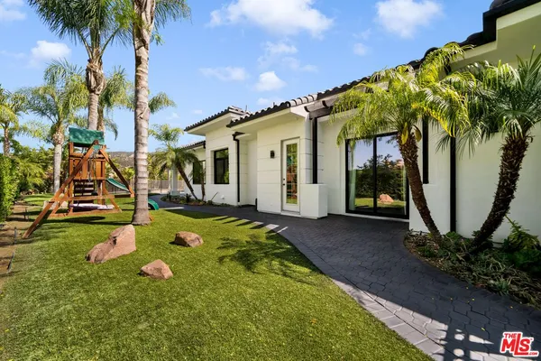 a view of a house with basketball court