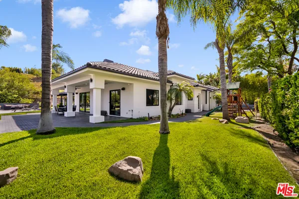 a view of a house with swimming pool and porch