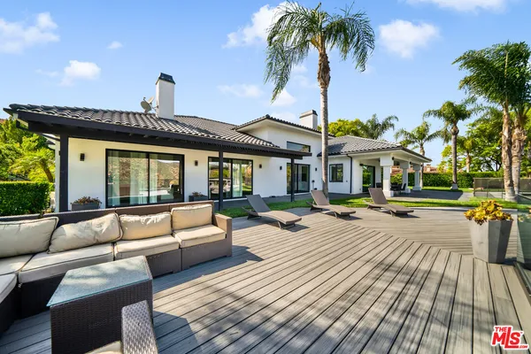 a view of a house with swimming pool and sitting area