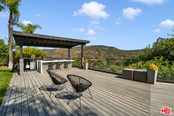 a view of balcony with furniture and wooden floor
