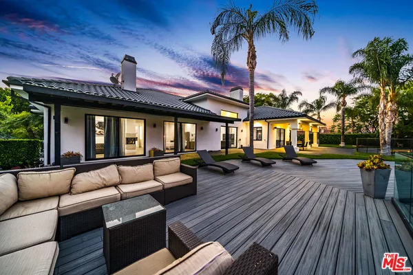 a view of a patio with couches and potted plants
