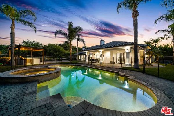 swimming pool view with a seating space