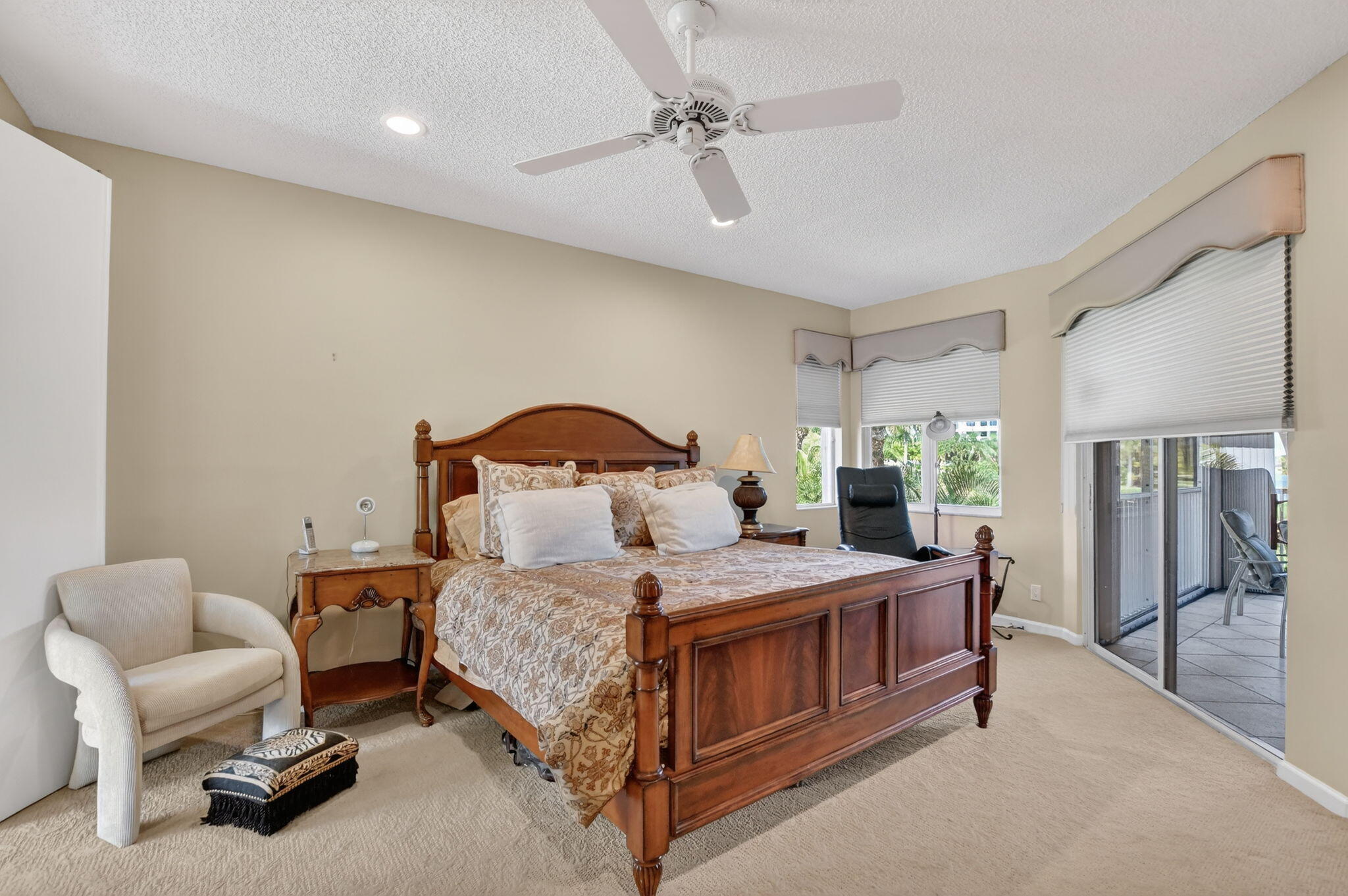 20220 Boca W Drive, Unit 702 Boca Raton, FL 33434 - Photo 14 of 51 a bedroom with a bed a chandelier and a dresser