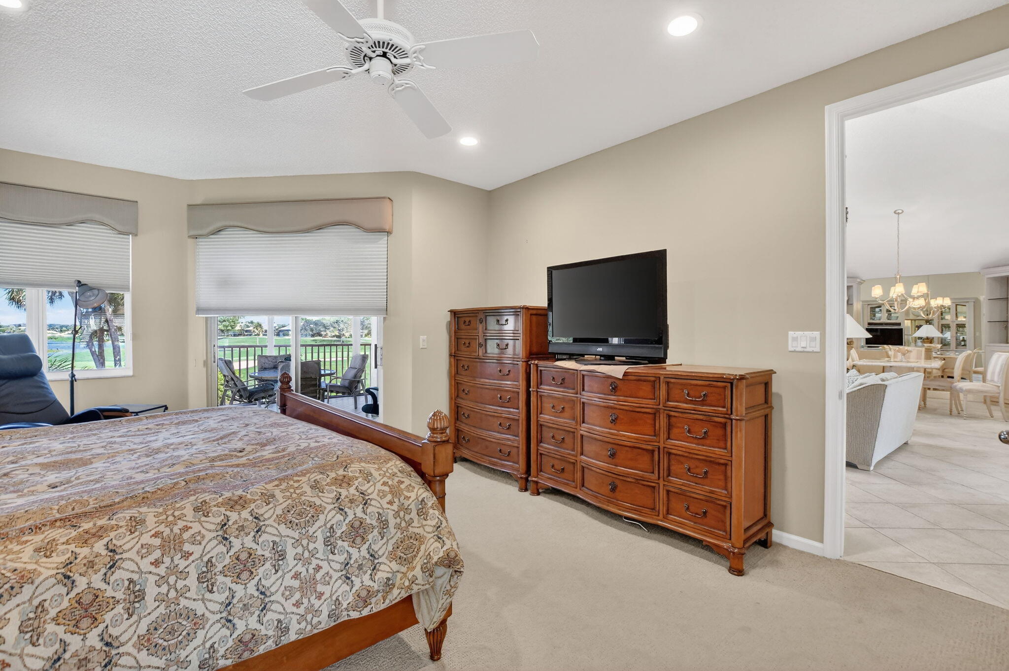 20220 Boca W Drive, Unit 702 Boca Raton, FL 33434 - Photo 16 of 51 a bedroom with a bed and a flat screen tv
