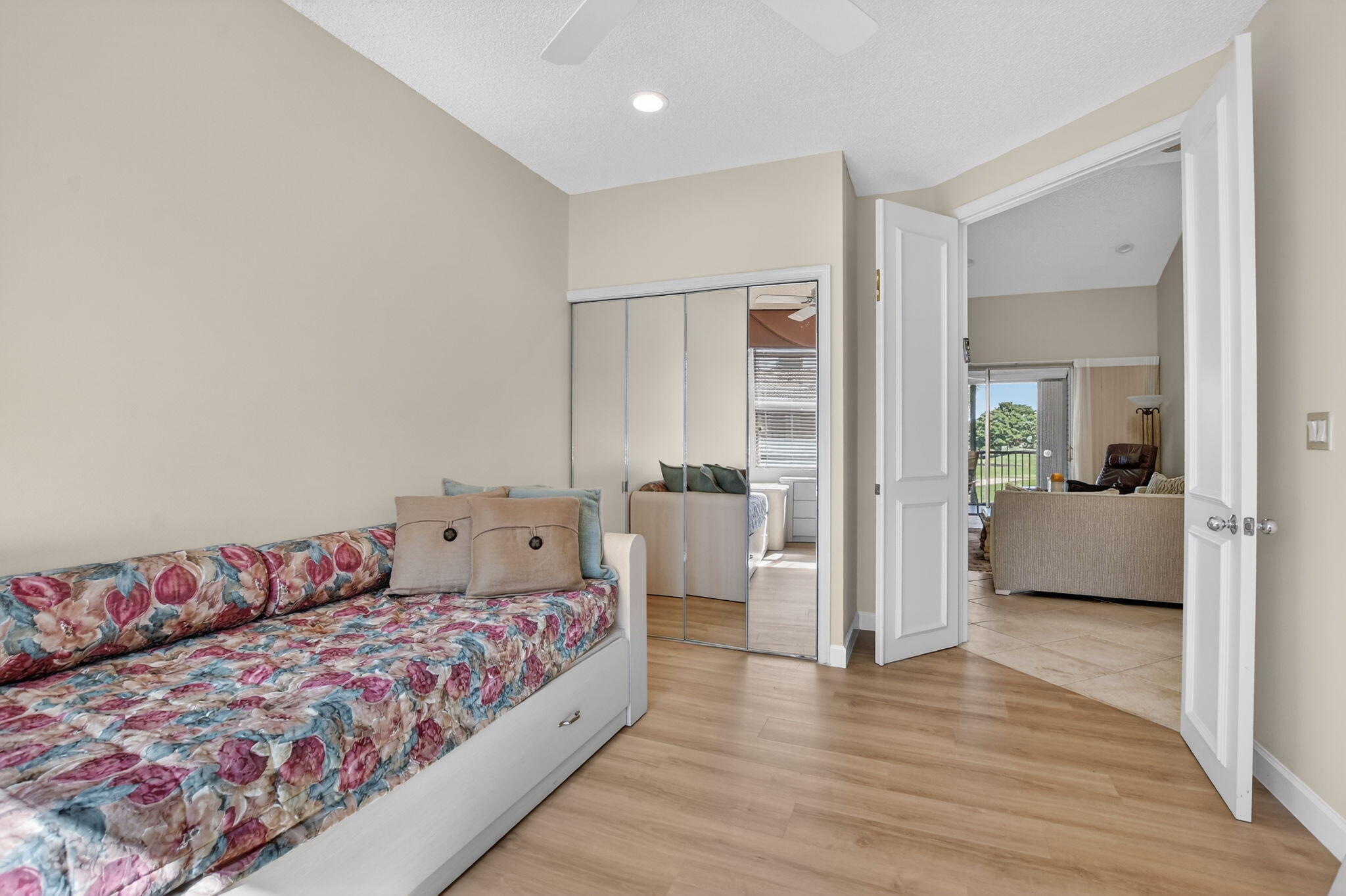 20220 Boca W Drive, Unit 702 Boca Raton, FL 33434 - Photo 25 of 51 a bedroom with a large bed and wooden floor