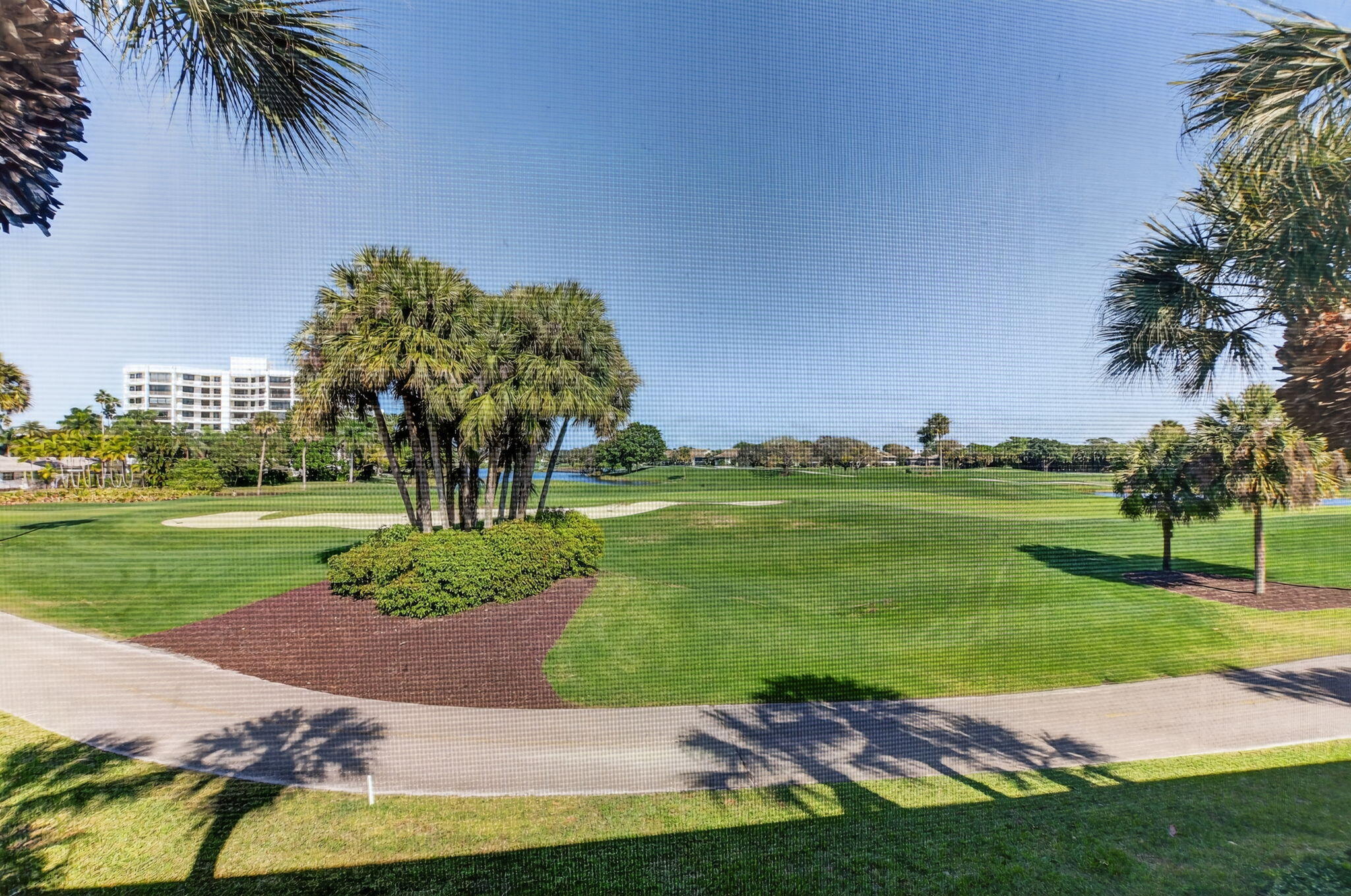 20220 Boca W Drive, Unit 702 Boca Raton, FL 33434 - Photo 29 of 51 a view of a swimming pool and a yard
