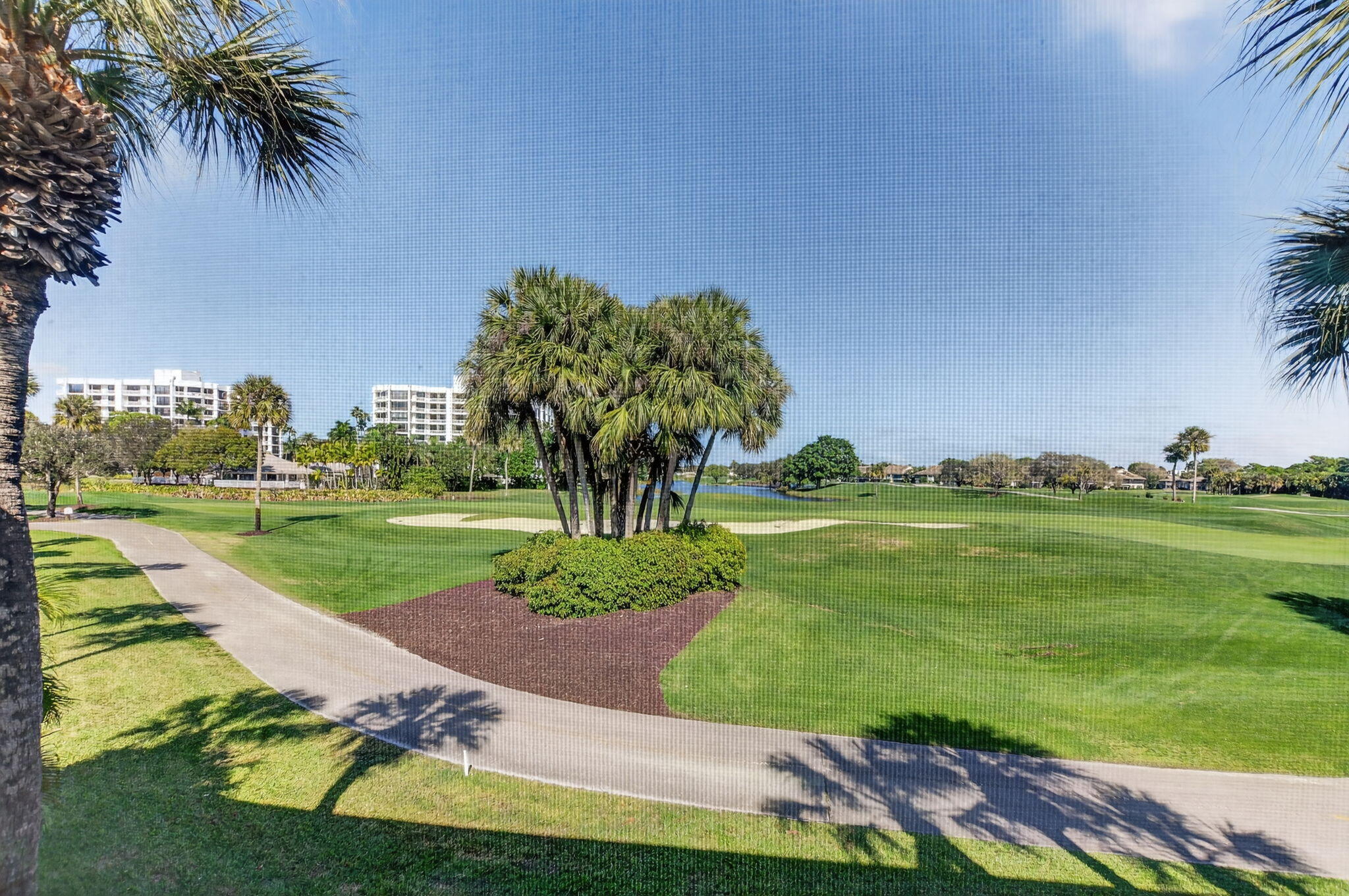 20220 Boca W Drive, Unit 702 Boca Raton, FL 33434 - Photo 30 of 51 a view of a park with large trees and cars parked