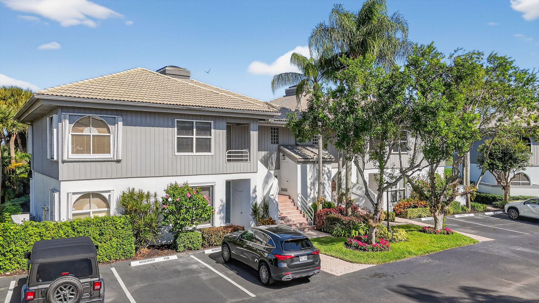 20220 Boca W Drive, Unit 702 Boca Raton, FL 33434 - Photo 31 of 51 a car parked in front of a white house