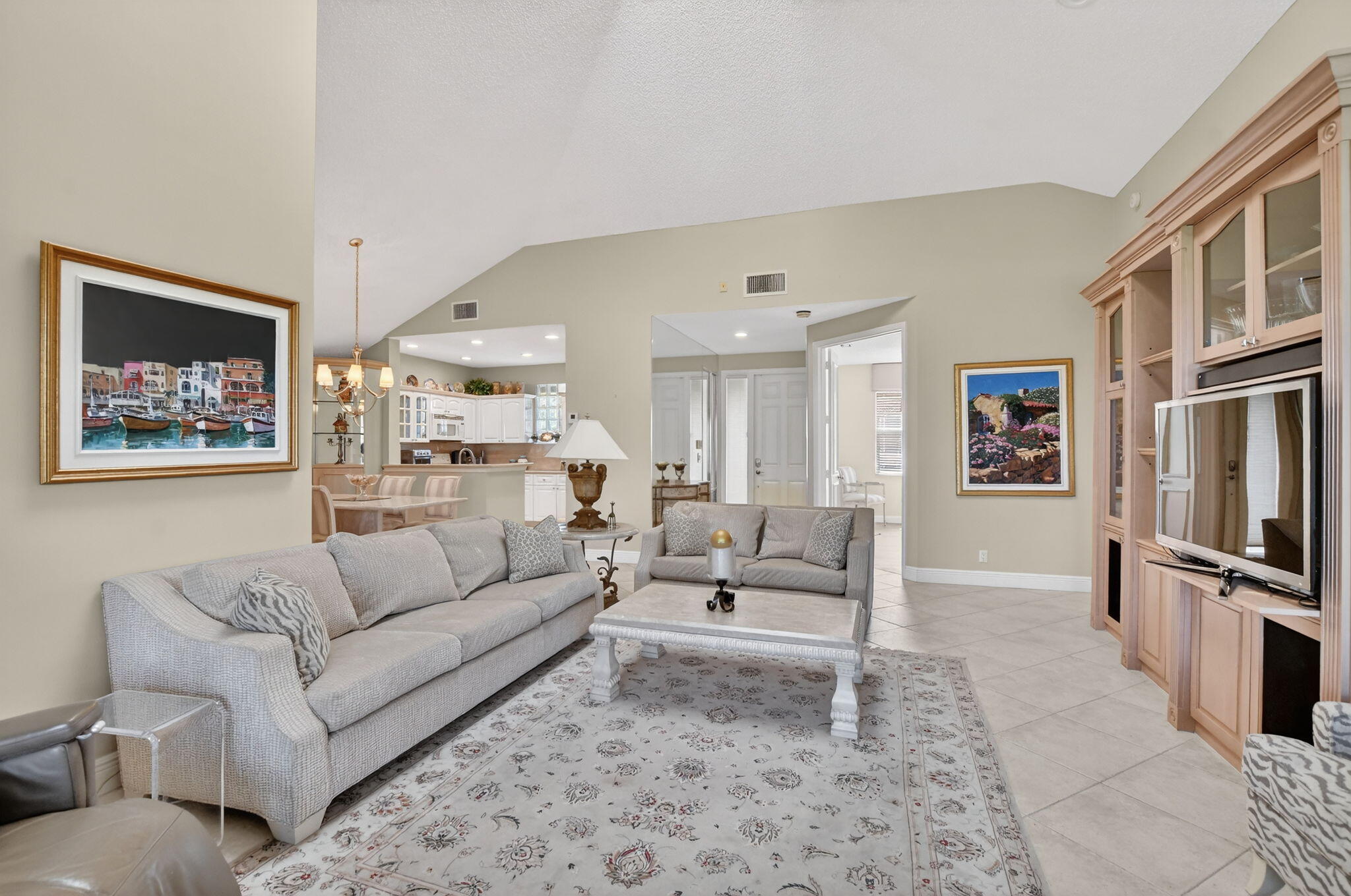 20220 Boca W Drive, Unit 702 Boca Raton, FL 33434 - Photo 4 of 51 a living room with furniture and a flat screen tv