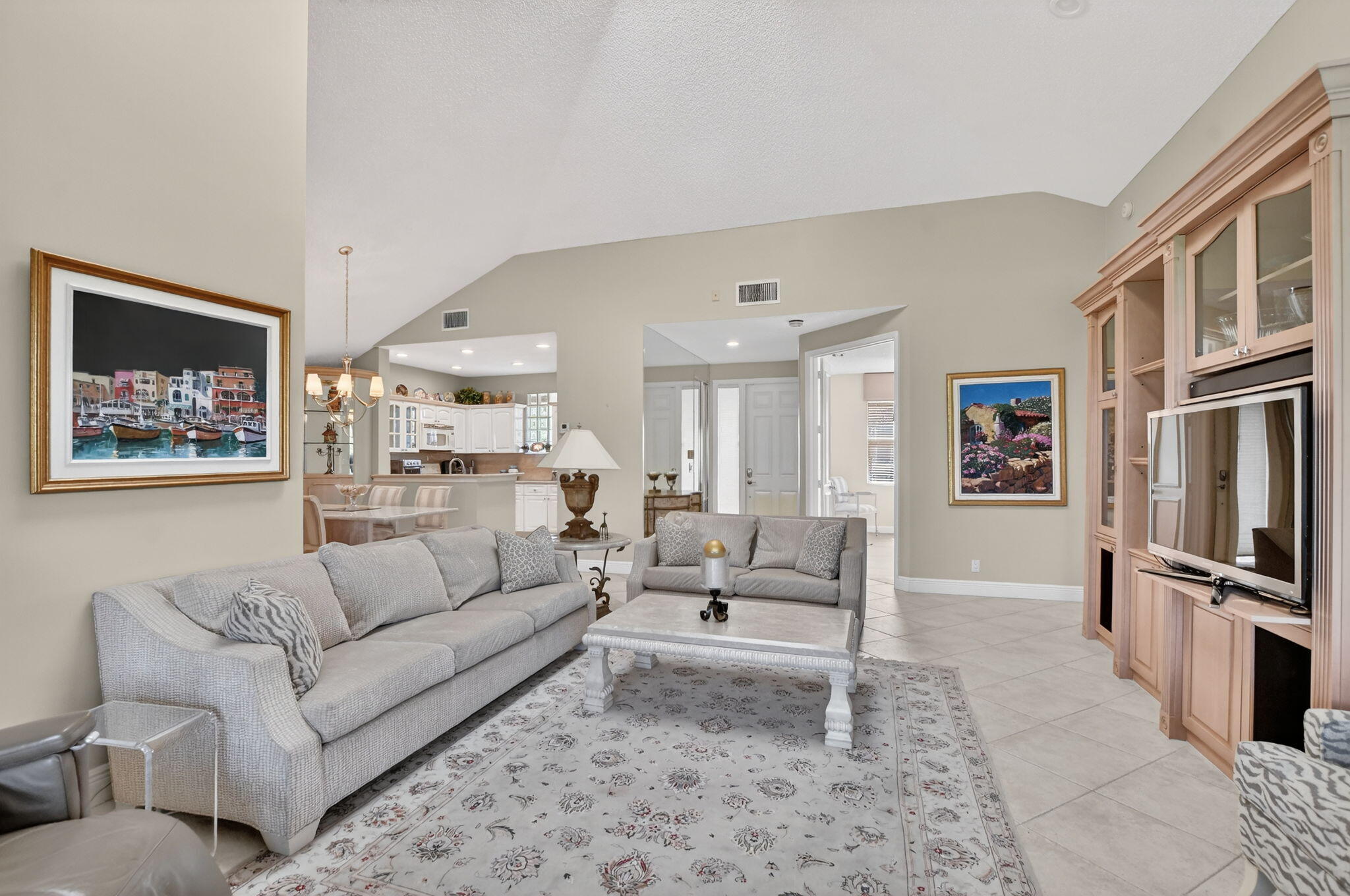 20220 Boca W Drive, Unit 702 Boca Raton, FL 33434 - Photo 5 of 51 a living room with furniture ceiling fan and a rug