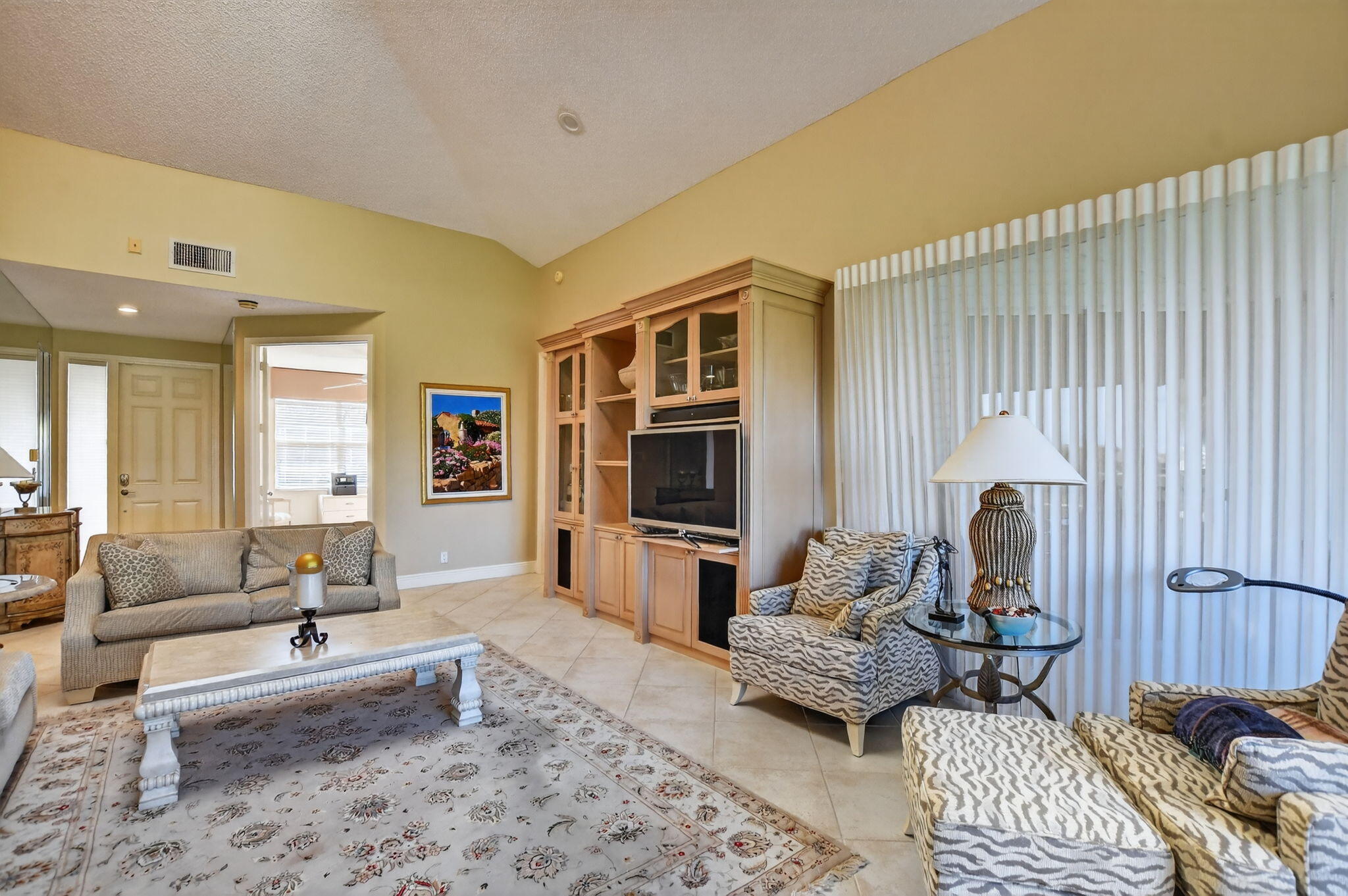 20220 Boca W Drive, Unit 702 Boca Raton, FL 33434 - Photo 6 of 51 a living room with furniture and a flat screen tv