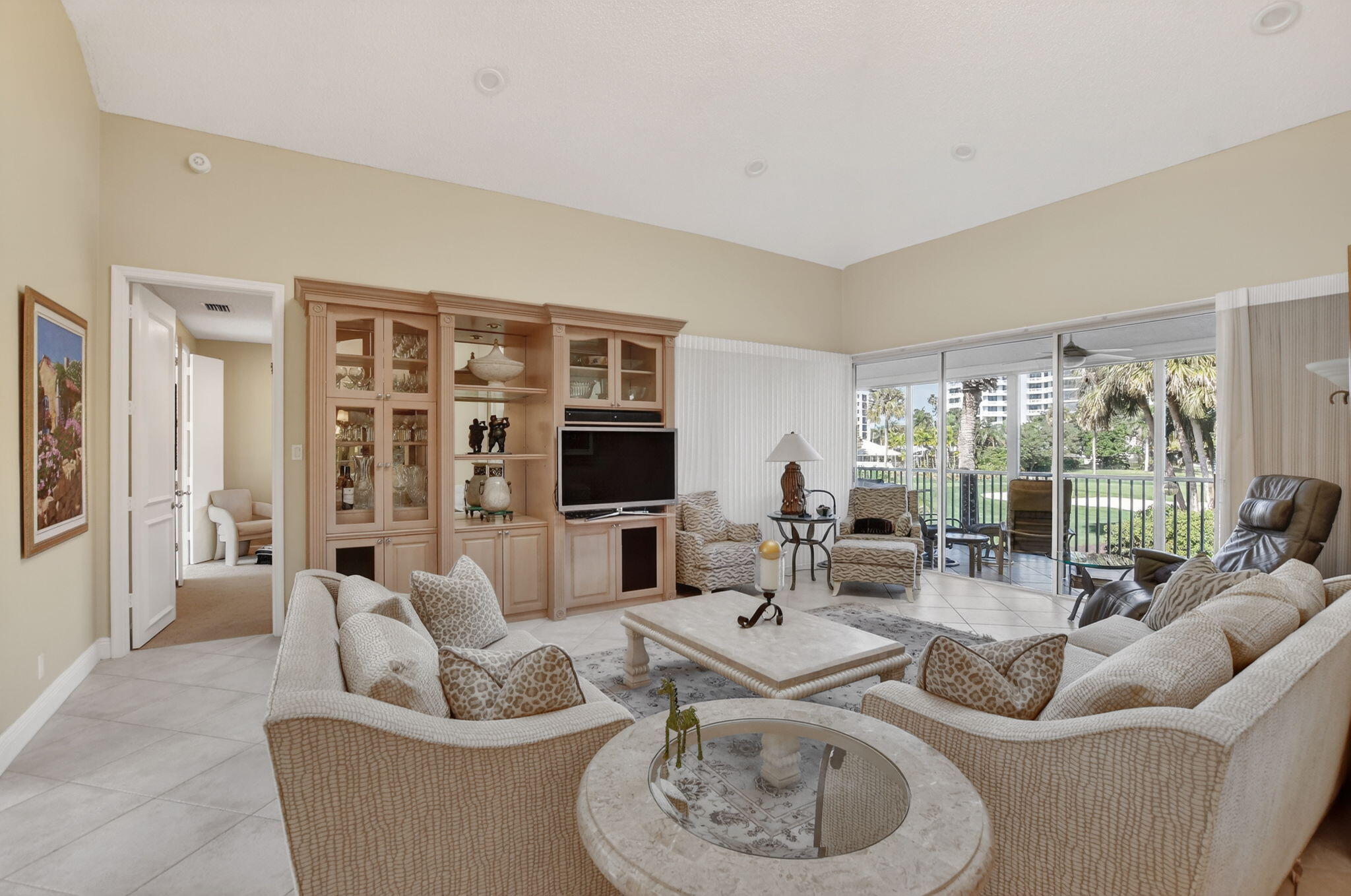 20220 Boca W Drive, Unit 702 Boca Raton, FL 33434 - Photo 7 of 51 a living room with furniture and a flat screen tv