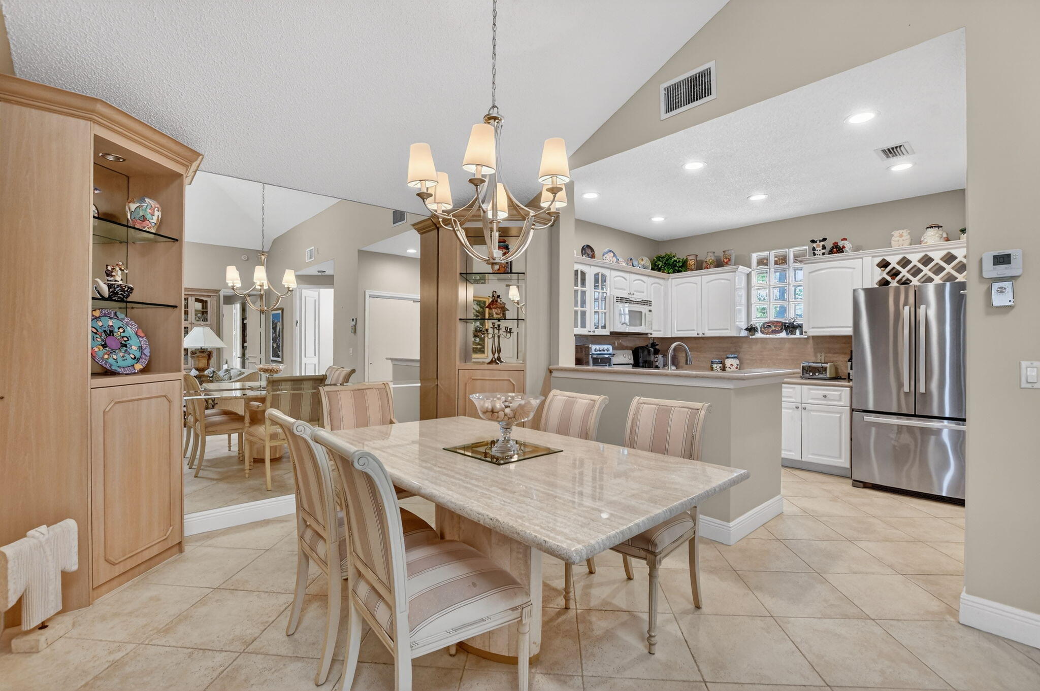 20220 Boca W Drive, Unit 702 Boca Raton, FL 33434 - Photo 8 of 51 a kitchen with kitchen island a large counter top space appliances and cabinets