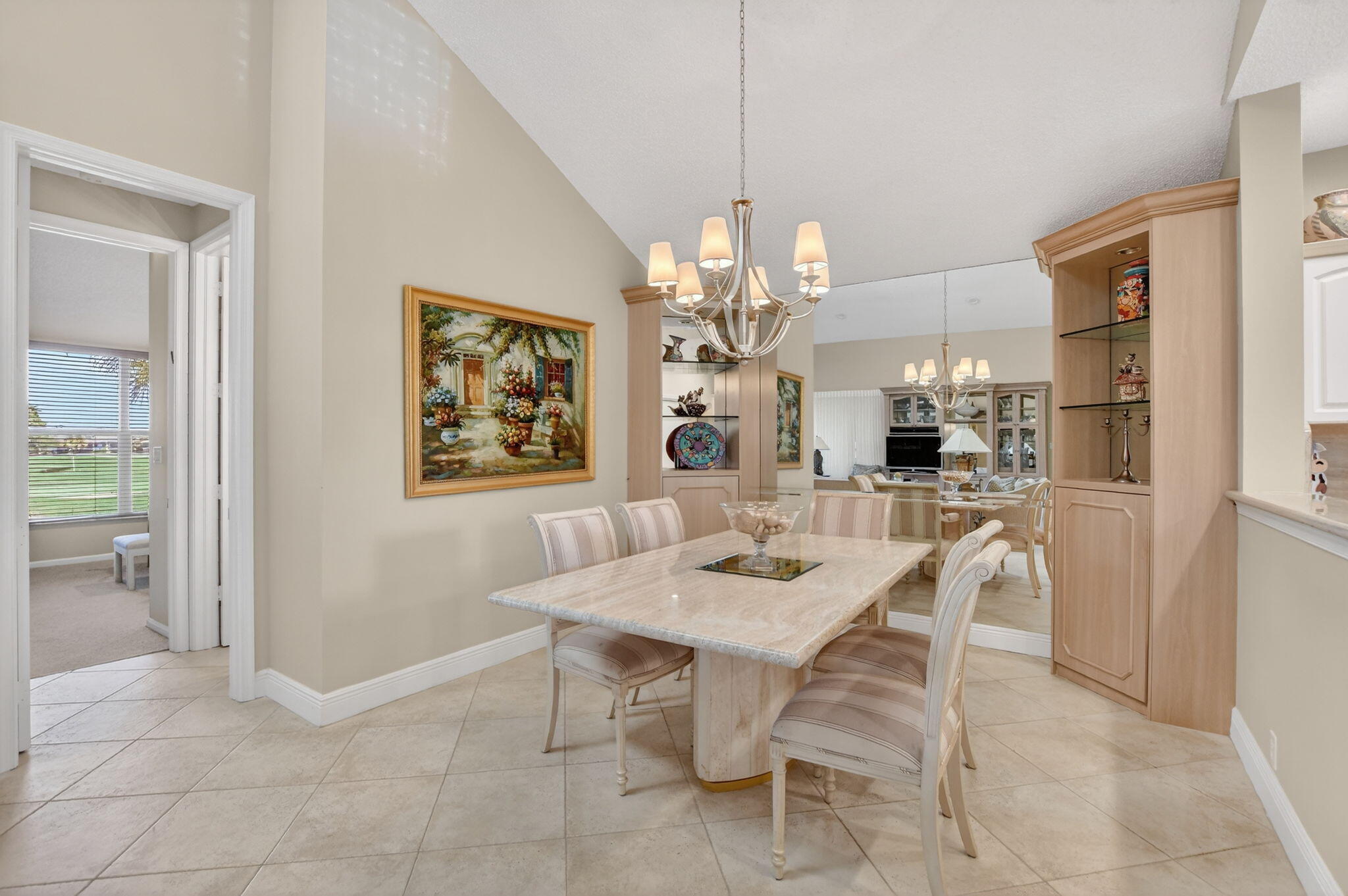 20220 Boca W Drive, Unit 702 Boca Raton, FL 33434 - Photo 9 of 51 a view of a dining room with furniture and chandelier