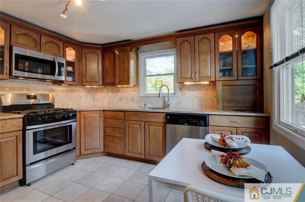 194 East Cliff Road Colonia, NJ 07067 - Photo 11 of 22 a kitchen with stainless steel appliances a stove a sink and a microwave