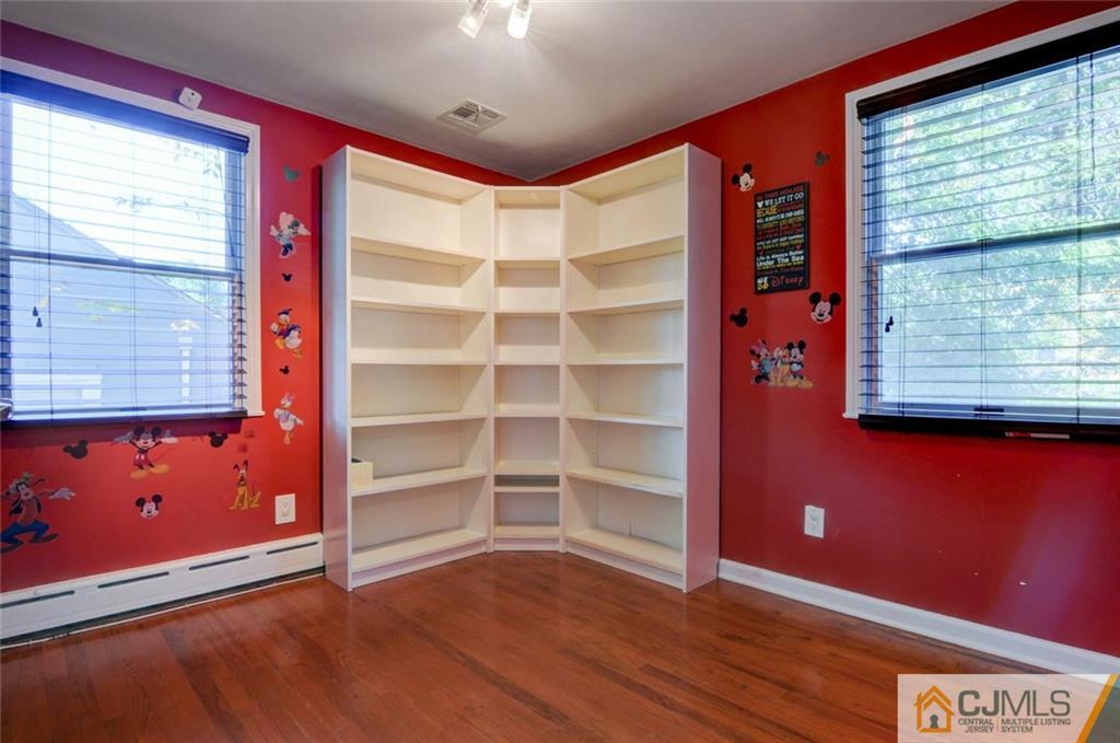 194 East Cliff Road Colonia, NJ 07067 - Photo 12 of 22 a view of an empty room with a window and wooden floor