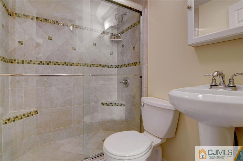 194 East Cliff Road Colonia, NJ 07067 - Photo 13 of 22 a bathroom with a sink a toilet and shower