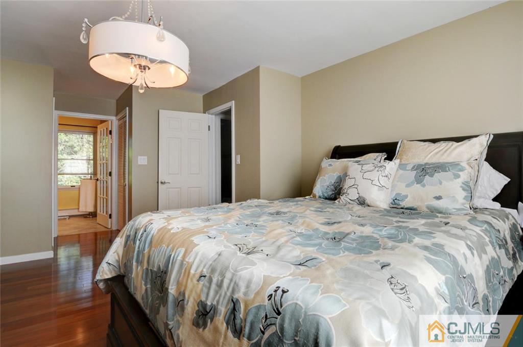 194 East Cliff Road Colonia, NJ 07067 - Photo 16 of 22 a bedroom with a bed and a chandelier