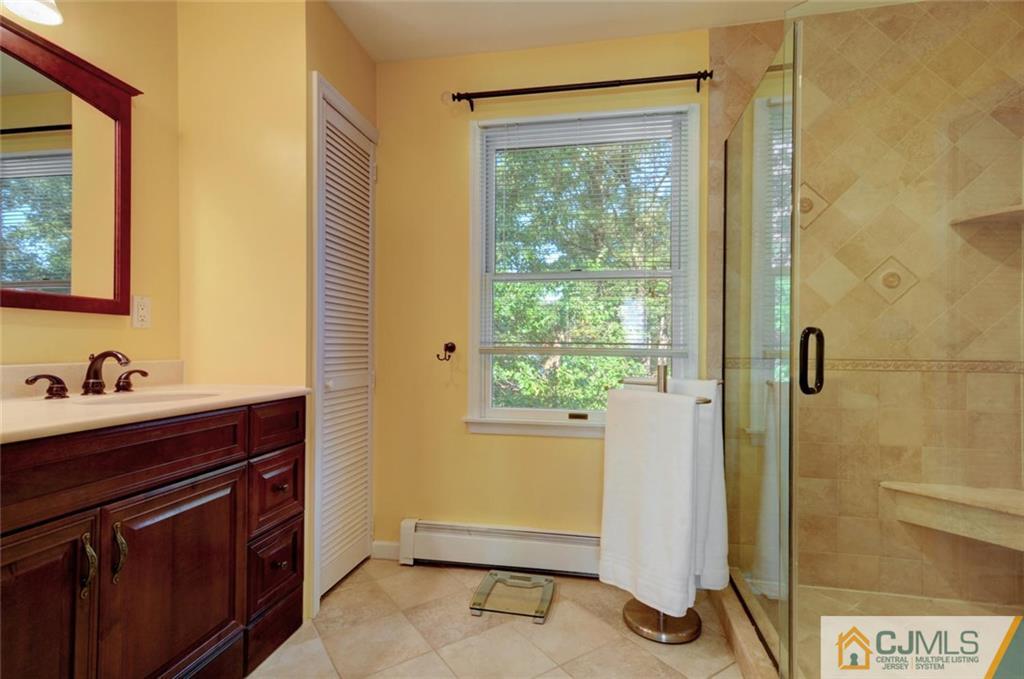 194 East Cliff Road Colonia, NJ 07067 - Photo 17 of 22 a bathroom with a sink and a mirror