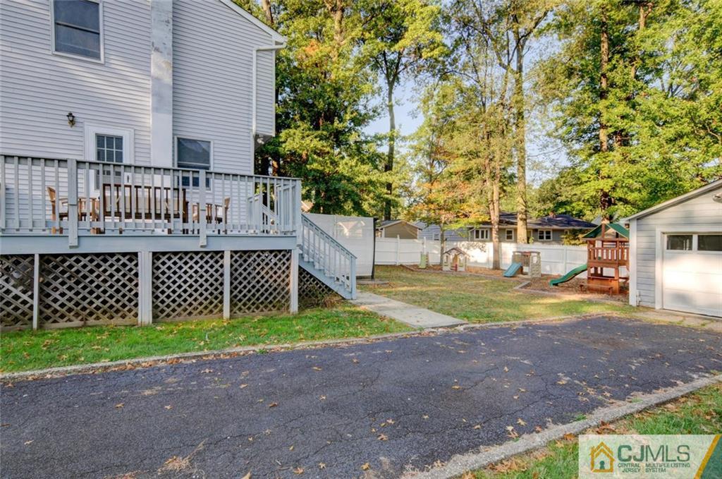 194 East Cliff Road Colonia, NJ 07067 - Photo 19 of 22 a view of a house with a yard and table and chair