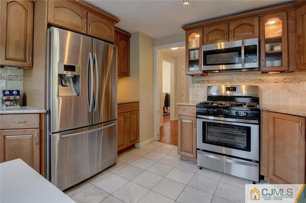 194 East Cliff Road Colonia, NJ 07067 - Photo 6 of 22 a kitchen with stainless steel appliances a refrigerator stove and microwave
