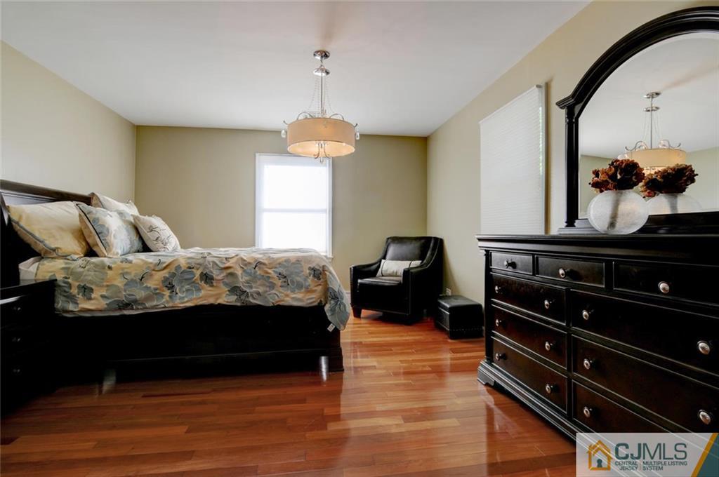 194 East Cliff Road Colonia, NJ 07067 - Photo 7 of 22 a bedroom with a bed and wooden floor
