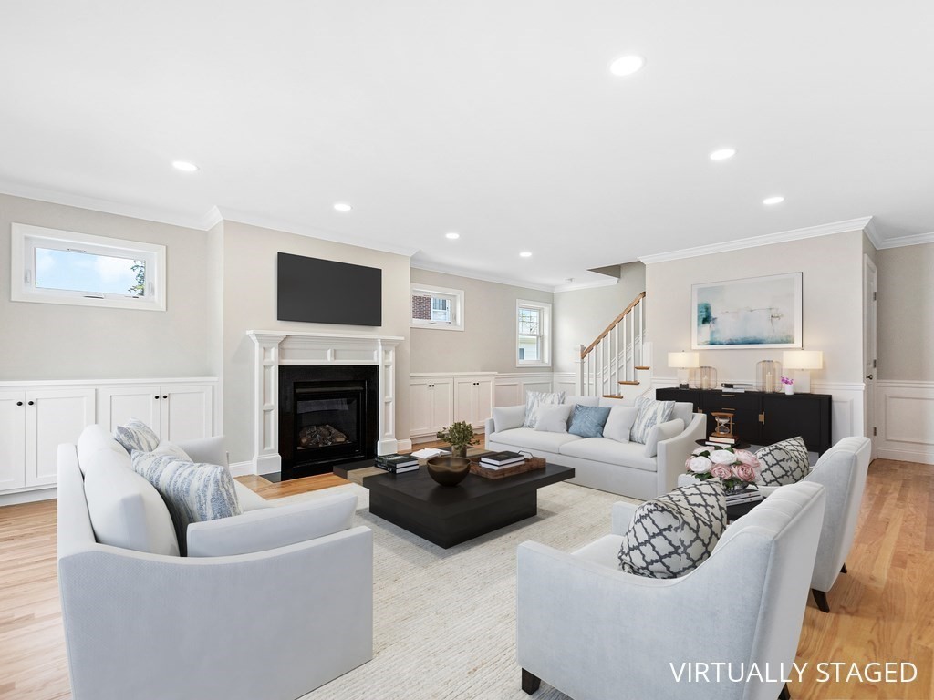 125 Thornton Road Waltham, MA 02453 - Photo 14 of 42 a living room with furniture a fireplace and a flat screen tv
