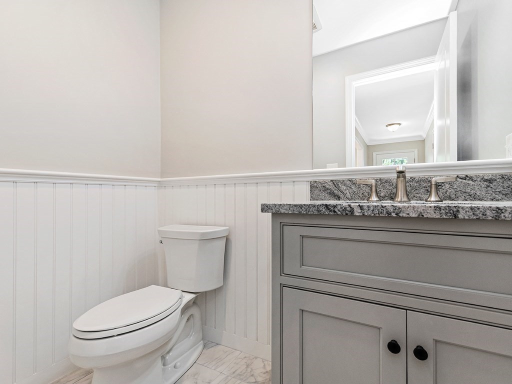 125 Thornton Road Waltham, MA 02453 - Photo 23 of 42 a bathroom with a granite countertop toilet sink and mirror