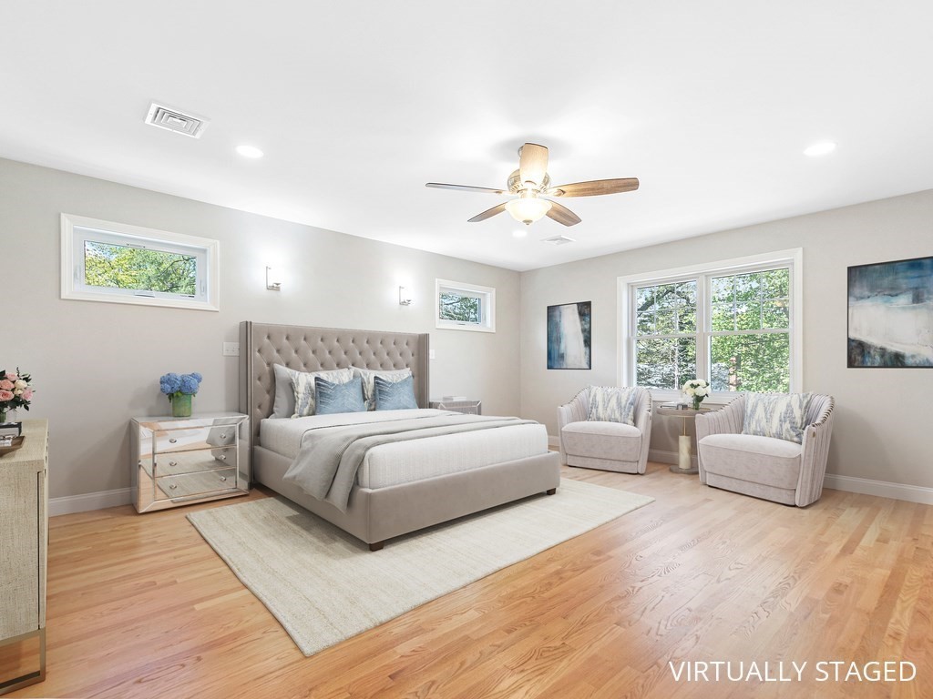 125 Thornton Road Waltham, MA 02453 - Photo 24 of 42 a spacious bedroom with a large bed and a couch