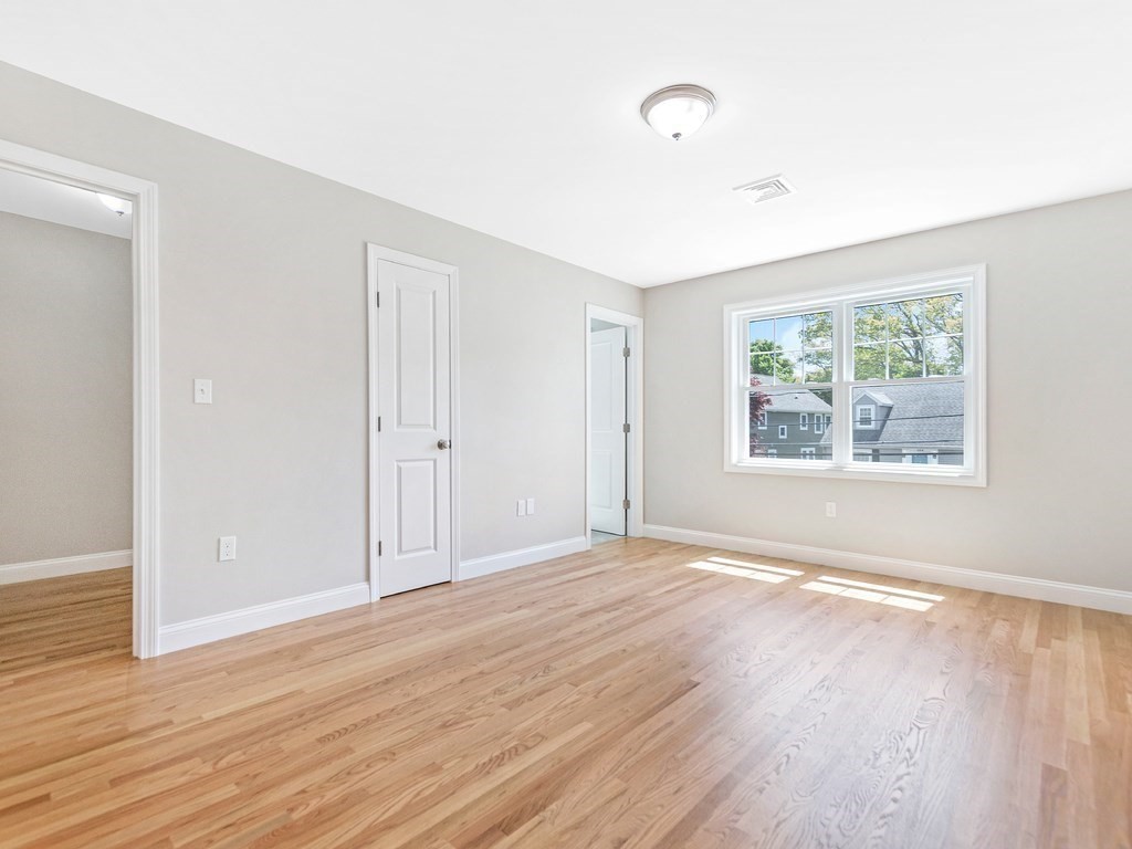 125 Thornton Road Waltham, MA 02453 - Photo 27 of 42 a view of an empty room with wooden floor and a window