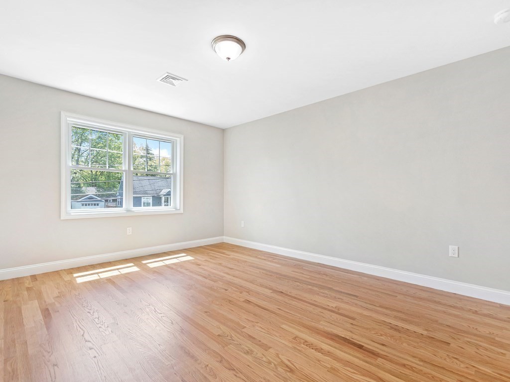 125 Thornton Road Waltham, MA 02453 - Photo 28 of 42 an empty room with wooden floor and windows