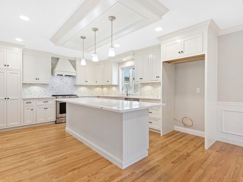 125 Thornton Road Waltham, MA 02453 - Photo 3 of 42 a large kitchen with stainless steel appliances granite countertop a white cabinets and wooden floors