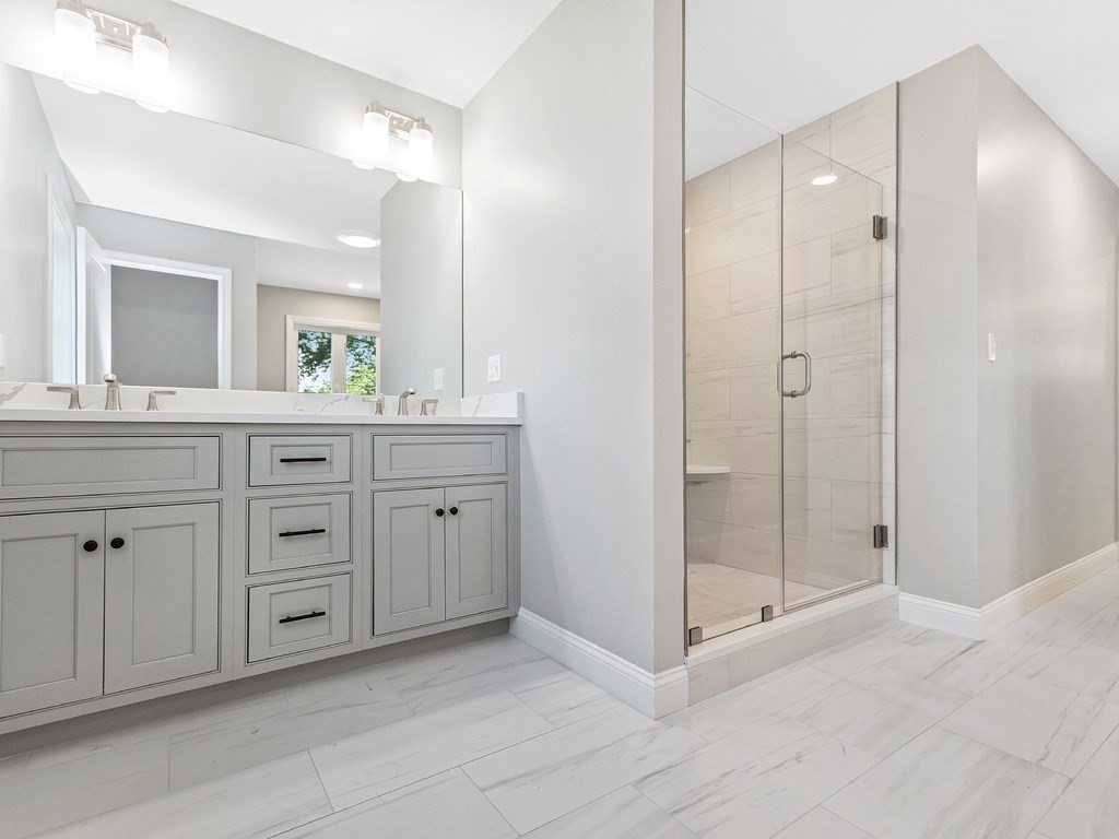 125 Thornton Road Waltham, MA 02453 - Photo 32 of 42 a spacious bathroom with a granite countertop sink mirror and double
