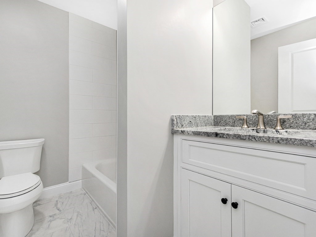 125 Thornton Road Waltham, MA 02453 - Photo 33 of 42 a bathroom with a granite countertop toilet and sink